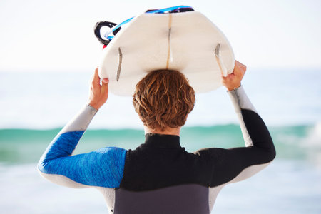 Surfing, sports and man by sea for fitness, exercise or training and walking to ocean water....