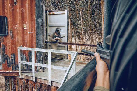 POV, aim and rifle by shooter shooting in airsoft match or combat competition as extreme sports on a battlefield. Gun, target and military player or soldier in a war for survival using weaponの写真素材