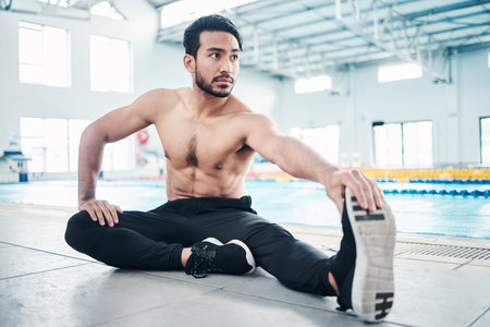 Athlete, fitness and man stretching by a pool ready for training, practice or exercise for a...