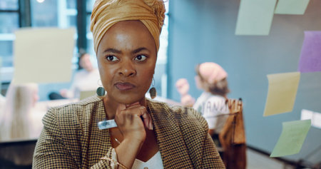 Black business woman, post it and writing planning notes on glass wall for business meeting,...