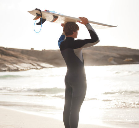 Surfer on beach, sun and man with surfboard on head, looking at ocean view with travel and nature...