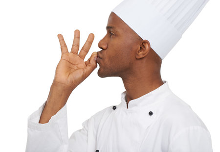 Magnifique. Profile of an african chef kissing his hand in perfection.の写真素材
