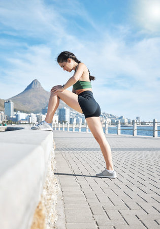 Fitness, woman and stretching legs in Cape Town for running, exercise or cardio workout by the...