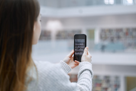 Phone, photography and student in library for research update, social media post or content creation...