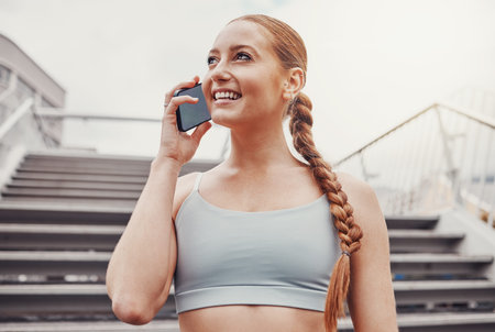 City, fitness and woman with smartphone on call, communication, smile and talking after exercise....