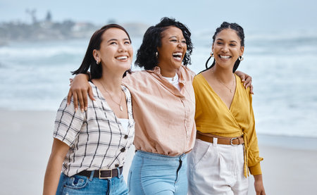 Friends, diversity and beach, hug and walk while laughing, relax and talking against nature background. Travel, women and group embrace while walking at the sea, happy and smile on ocean trip in Baliの写真素材