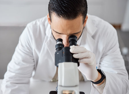Science, microscope and a doctor man at work in a laboratory for innovation or research. Medical,...