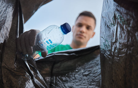 Recycle, bottle and man with view in bag, sustainability and cleaning plastic pollution for earth...