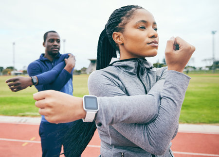 Fitness, black couple and stretching arms for exercise, health and wellness at stadium. Winter...