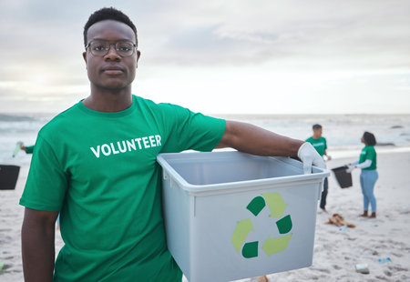 Cleaning, recycling and portrait of black man on beach for sustainability, environment or eco...
