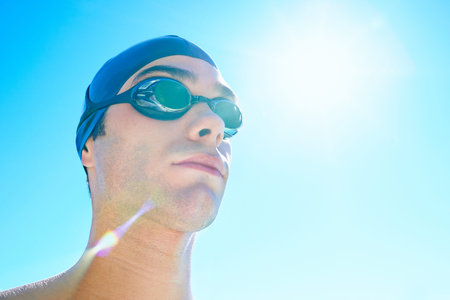 Winning is the only option. Cropped view of a male swimmer outdoors and looking away.
