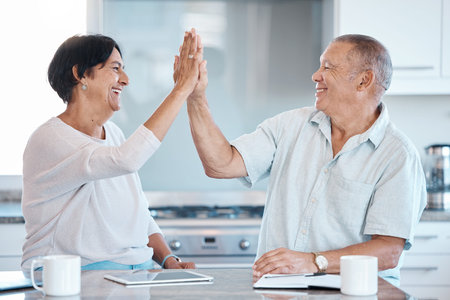 High five, tablet and senior couple in kitchen happy for success in online banking, ecommerce and...