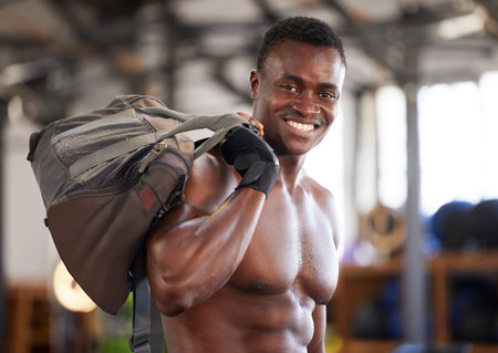 Black man in fitness portrait and bodybuilder with gym bag smile and strong with muscle training mockup. Happy person after workout, cardio and muscular, health and active lifestyle with bodybuildingの写真素材