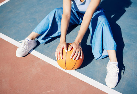 Basketball, hands and woman on the outdoor court floor with urban fashion for influencer beauty....