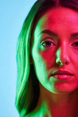Half portrait, skincare or glowing neon lighting on isolated blue background in self love or...