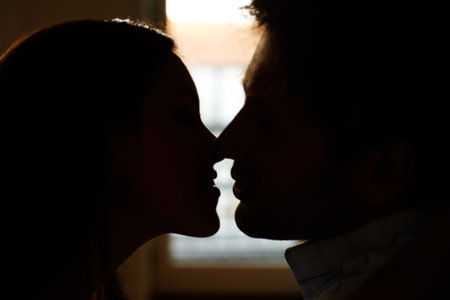 An intimate moment. Profile view of a romantic young couple about to kiss.の写真素材