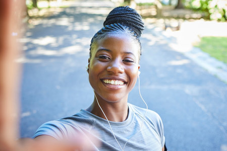 Selfie, fitness and portrait of black woman in park with smile for exercise goals, running and marathon training. Sports, picture and face of happy girl for cardio workout, healthy body and wellnessの写真素材