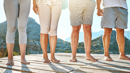 Close up of a group of seniors feet. Midsection of mature people standing barefoot in a row against...