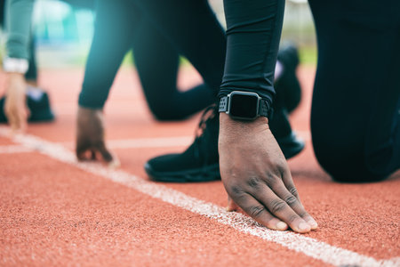 Athlete, runner and fitness person at start of a race on a sports track for exercise, workout or...