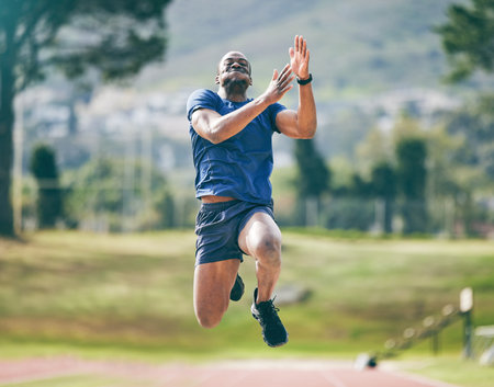 Black man, high jump and fitness exercise at stadium for training, workout or practice. Sports,...