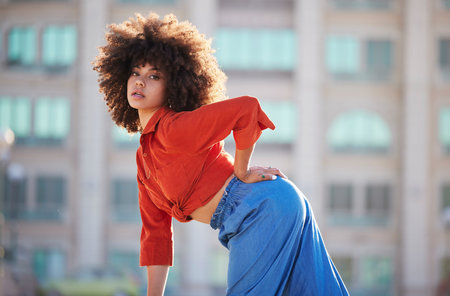 Black woman, fashion and beauty with portrait in city in street style, travel and natural hair,...
