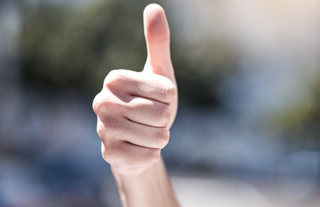 Were enacting positive change. a protestor giving the thumbs up during a rally.