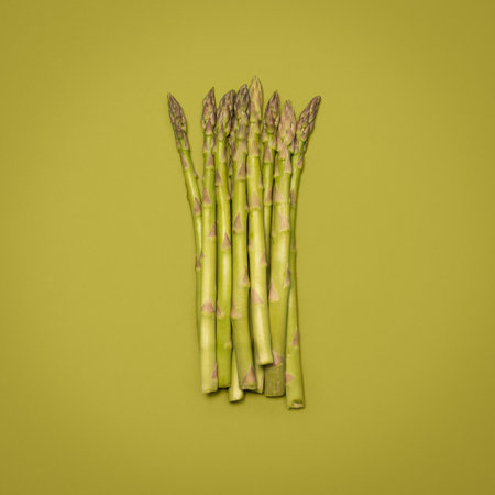 Green is good for you. a bunch of asparagus against a studio background.の写真素材