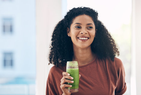 Idea, mock up and smoothie with a black woman drinking a health beverage for a weight loss diet or nutrition. Thinking, mockup and drink with a healthy young female enjoying a fresh fruit juiceの写真素材