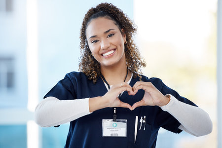 Nurse, portrait or heart hands in hospital wellness, medicine trust or medical support in life insurance, help or vote. Smile, happy or doctor with love gesture in healthcare, emoji or woman securityの写真素材