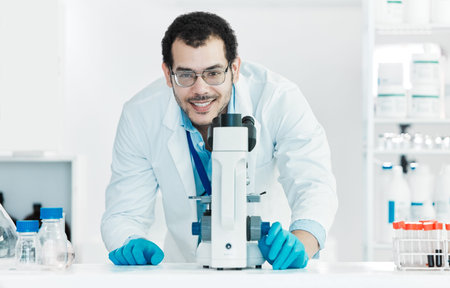Uncovering new phenomenon. Portrait of a young scientist using a microscope in a lab.