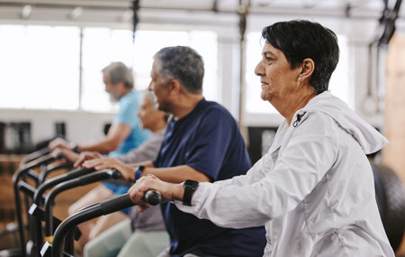 Senior workout group, exercise bike and cycling for fitness, health and retirement wellness by...