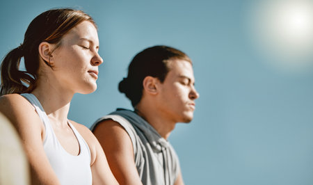 Fitness, exercise and meditation couple on blue sky mockup space for health and wellness outdoor. Man and woman in nature for workout, mental health and healthy lifestyle for body and mind in summerの写真素材