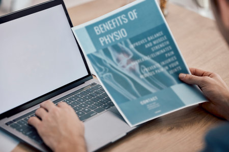 Man, hands and laptop with screen on mockup for physiotherapy research, typing or search on table....