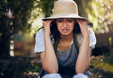 Push through the hard times. a young florist looking stressed while at work.