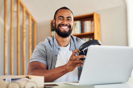 Time to start this day the right way. a handsome young businessman wearing headphones to listen to music.の写真素材
