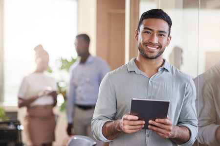 Positive updates are always thrilling. a young businessman using his digital tablet at work.