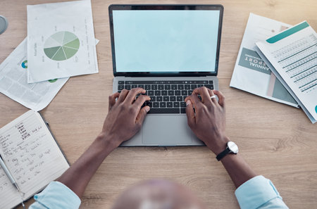 Business waits for no man. a businessman working at his desk using his laptop.の写真素材