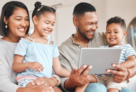 Say hello to your uncle. a young family happily bonding while using a digital tablet together on the...