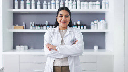 Portrait of a female scientist using a microscope in a research lab. Young biologist or biotechnology researcher working and analyzing microscopic samples with the latest laboratory tech equipmentの写真素材