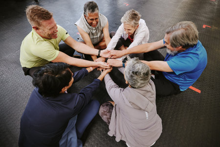 Top view, exercise and senior group holding hands, training goal and celebration for teamwork. Old...
