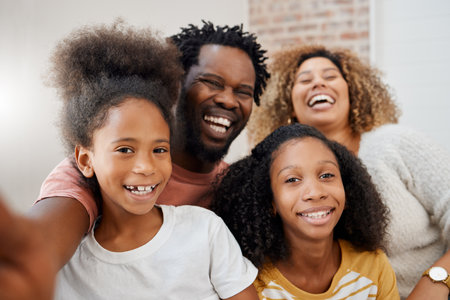 Family is the best team you could ever have. a young family taking a selfie at home.の写真素材
