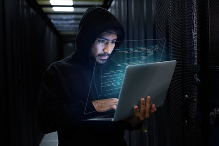 Cyber security, crime and hacker coding in server room with laptop at data center and stealing...