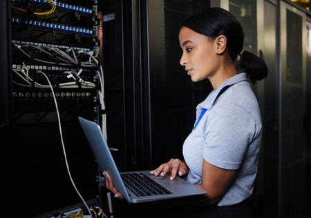 Engineer, laptop database and woman in server room for software update or maintenance at night....
