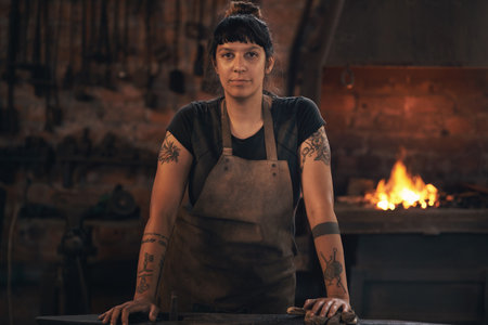 Dominating the industry like only she can. Portrait of a confident young woman working at a foundry.の写真素材