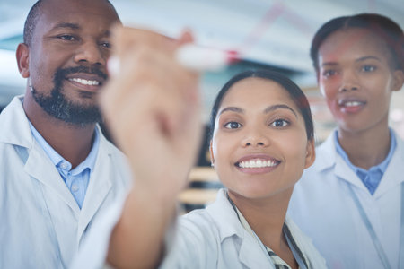 The brilliant minds behind the breakthrough. a group of scientists having a brainstorming session in a laboratory.の写真素材