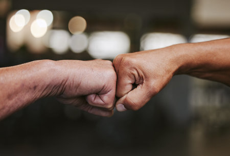 Hands, fist bump and fitness motivation for sports, greeting or team building in gym for wellness....