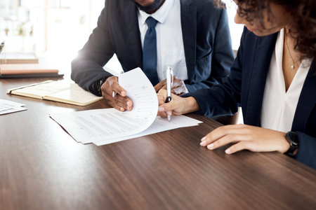 Lawyer, hands and contract with a business team at a desk in an office to sign documents. Teamwork,...