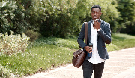 A true go getter has that forward moving mindset. a young businessman using a smartphone against an...