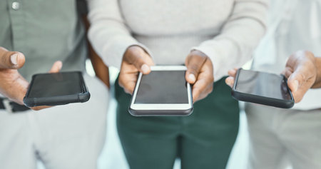 With technology, everyone stays informed. three businesspeople using digital tablet in an office.