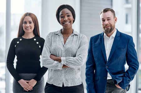 A dedicated team always finds success. Portrait of a group of businesspeople standing together in an...